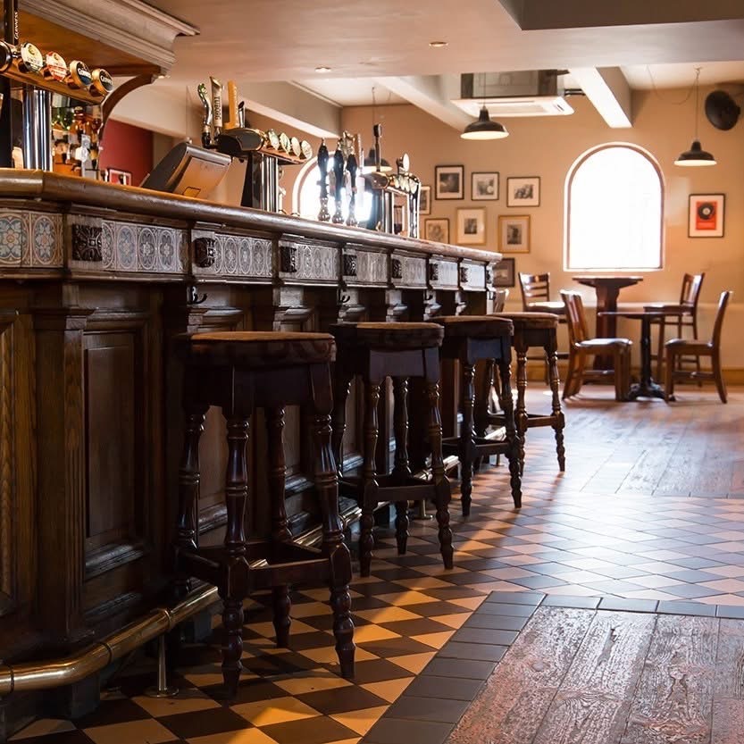 The bar and tiled floor inside The Charles Bradlaugh